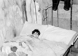 Mexican boy sick in bed.  San Antonio, Texas.