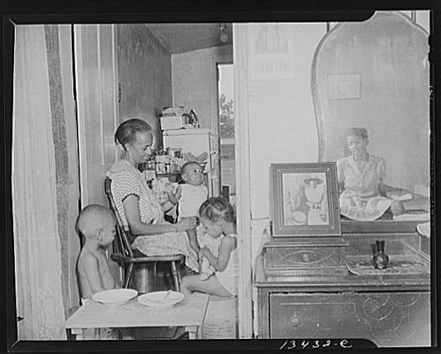 Washington, D.C. Mrs. Ella Watson, a government charwoman, with three grandchildren and her adopted daughter.